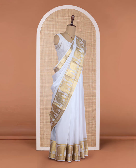 Cream plain Mysore silk saree, traditional zari border of elephant motifs, and pallu steeped with manga designs