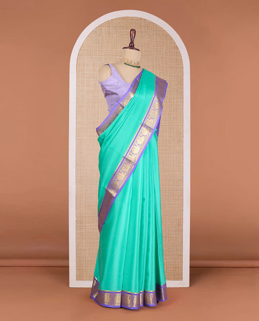 Green plain Mysore silk saree, contrast temple border of peacock motifs, and zari design pallu