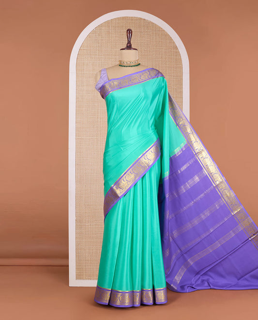 Green plain Mysore silk saree, contrast temple border of peacock motifs, and zari design pallu
