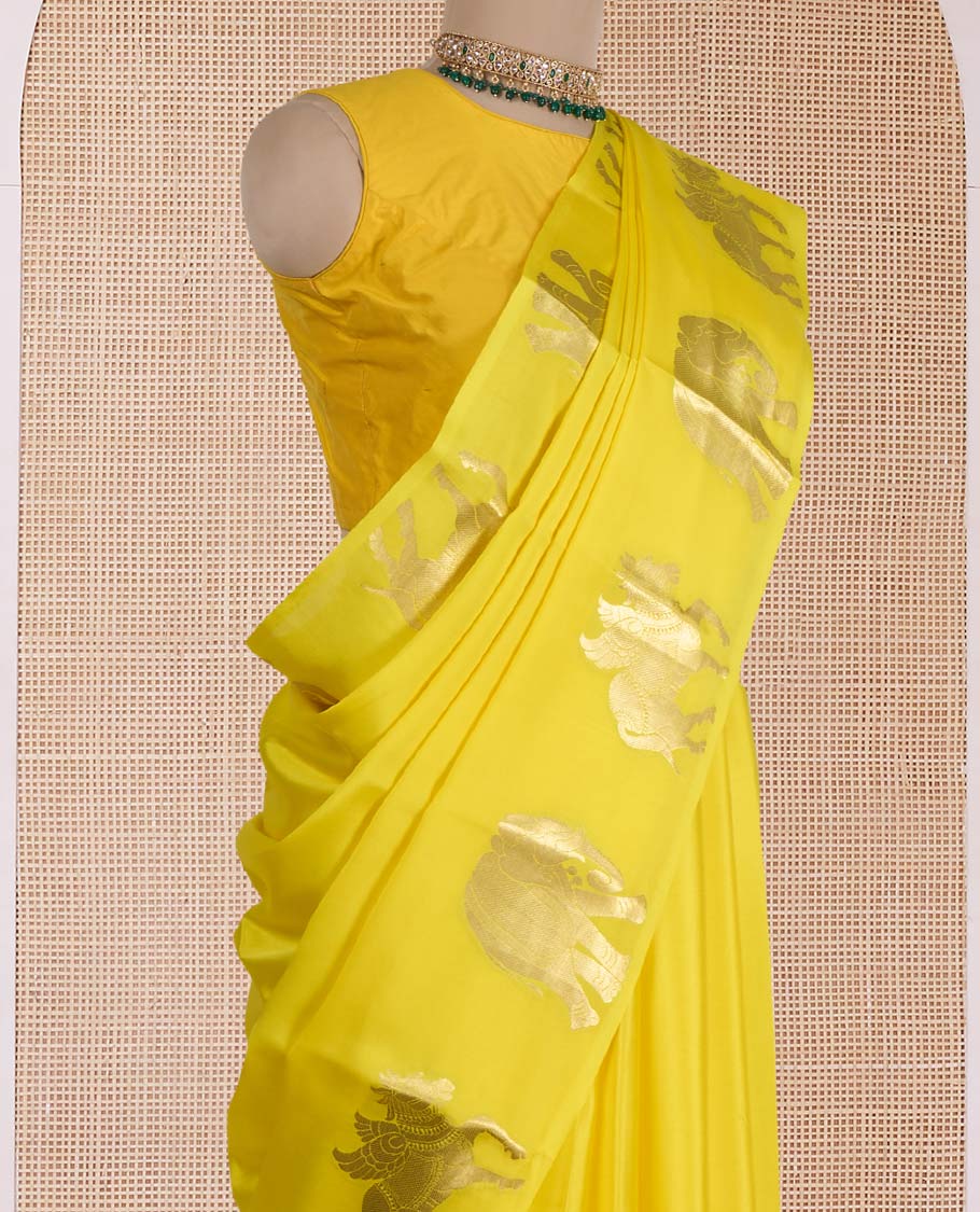 Yellow plain Mysore silk saree, zari border of elephant and kuthirai motifs, and pallu of minature animal motifs
