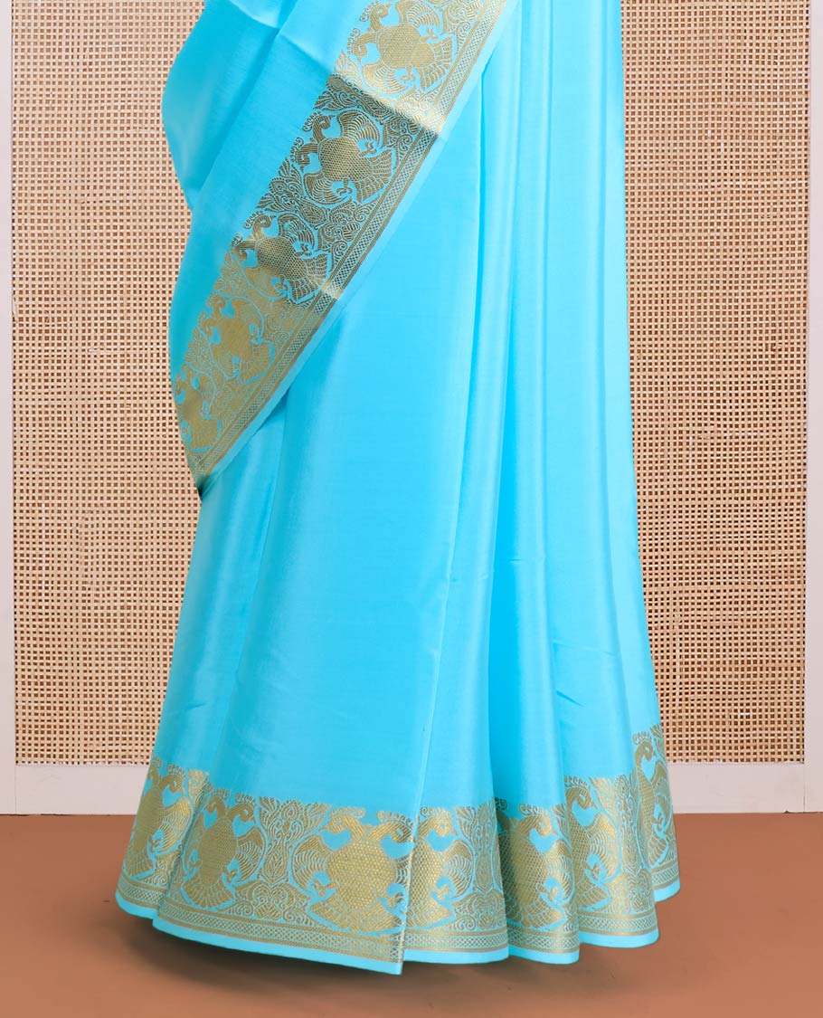 Blue plain Mysore silk saree, zari border of two-headed eagle motifs, and pallu steeped with two-headed eagle motifs
