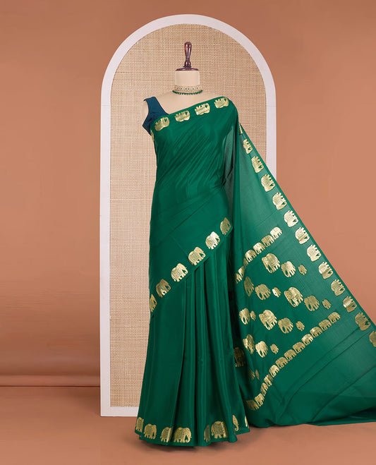 Green plain Mysore silk saree, zari border of elephant motifs, and pallu steeped with elephant motifs