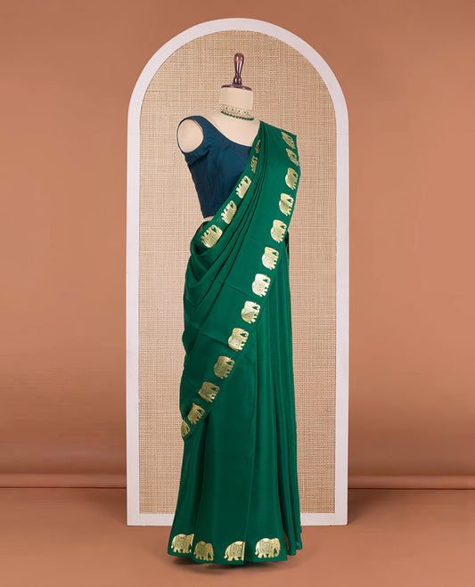 Green plain Mysore silk saree, zari border of elephant motifs, and pallu steeped with elephant motifs