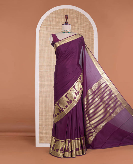 Maroon plain Mysore silk saree, traditional zari border of elephant motifs, and pallu steeepd with paisleys