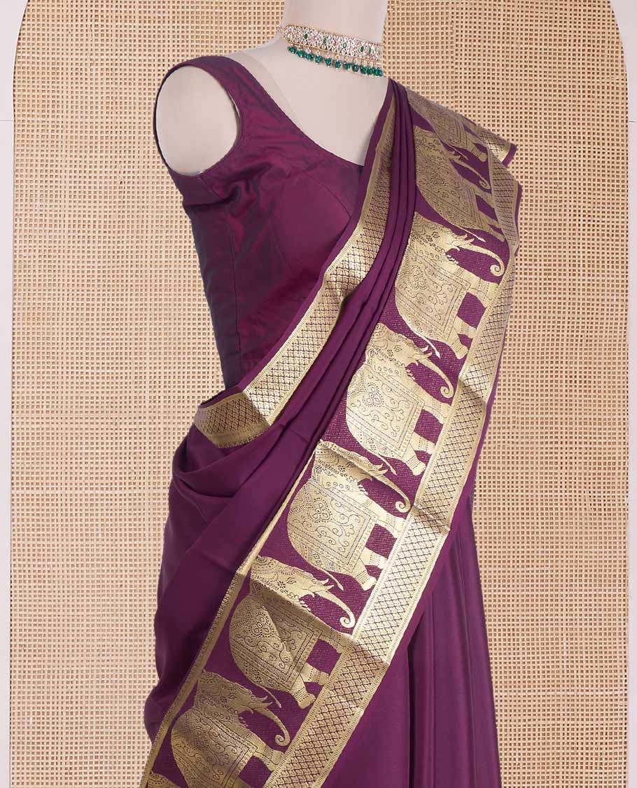 Maroon plain Mysore silk saree, traditional zari border of elephant motifs, and pallu steeepd with paisleys