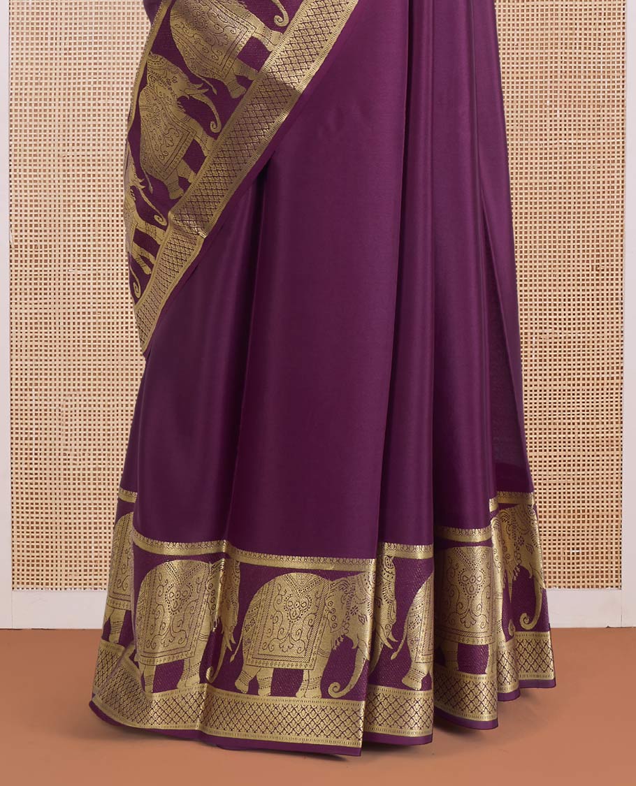 Maroon plain Mysore silk saree, traditional zari border of elephant motifs, and pallu steeepd with paisleys