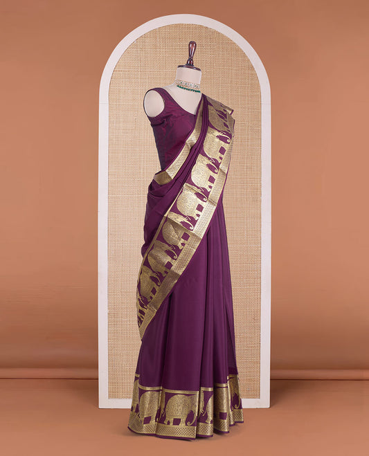 Maroon plain Mysore silk saree, traditional zari border of elephant motifs, and pallu steeepd with paisleys