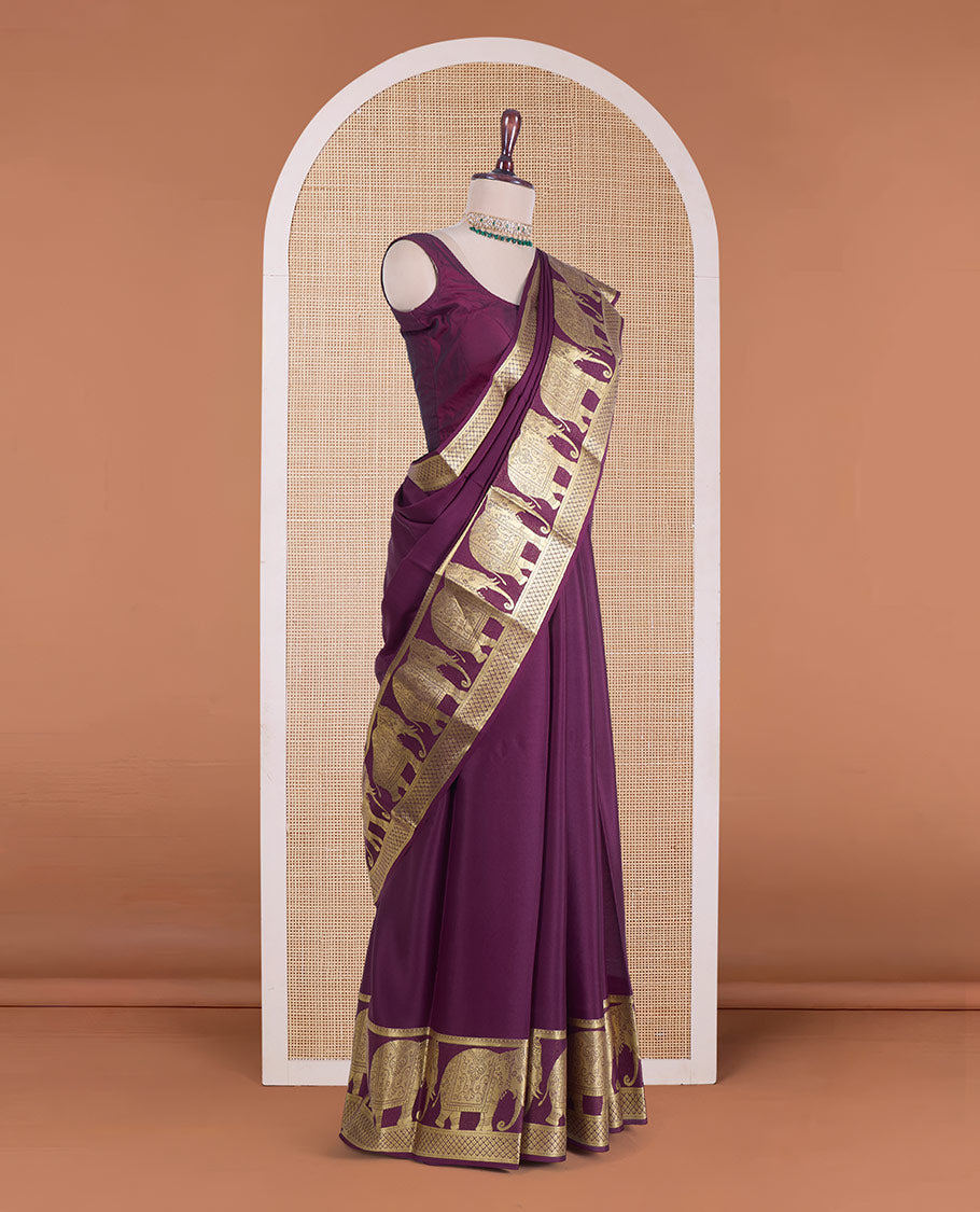 Maroon plain Mysore silk saree, traditional zari border of elephant motifs, and pallu steeepd with paisleys