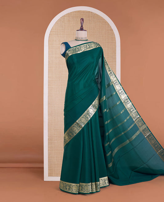 Green plain Mysore silk saree, zari border of Mythological animal characters, and zari striped pallu
