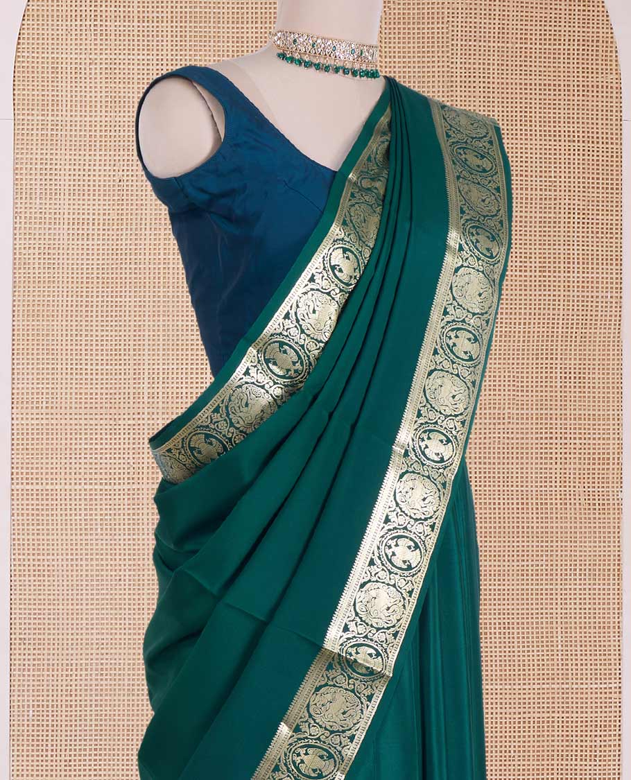 Green plain Mysore silk saree, zari border of Mythological animal characters, and zari striped pallu