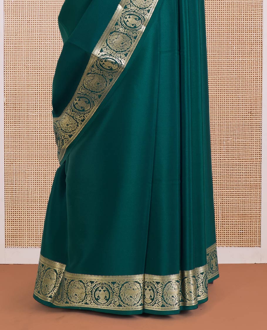 Green plain Mysore silk saree, zari border of Mythological animal characters, and zari striped pallu