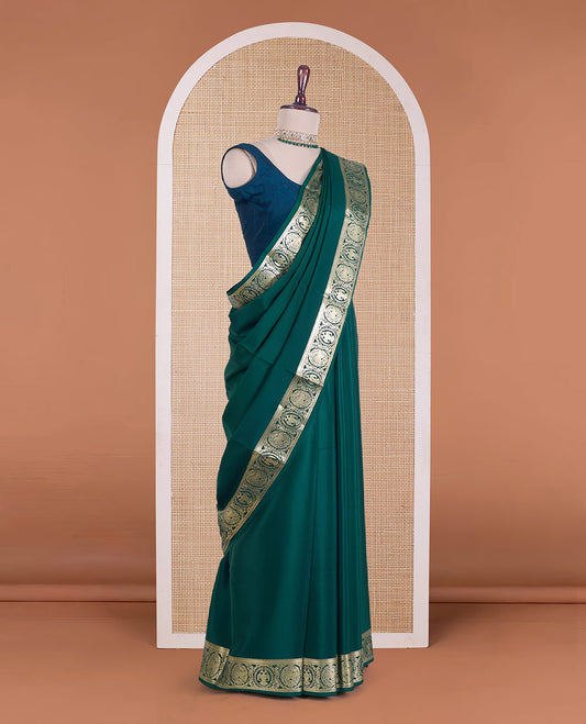 Green plain Mysore silk saree, zari border of Mythological animal characters, and zari striped pallu
