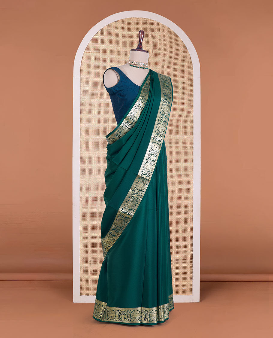 Green plain Mysore silk saree, zari border of Mythological animal characters, and zari striped pallu