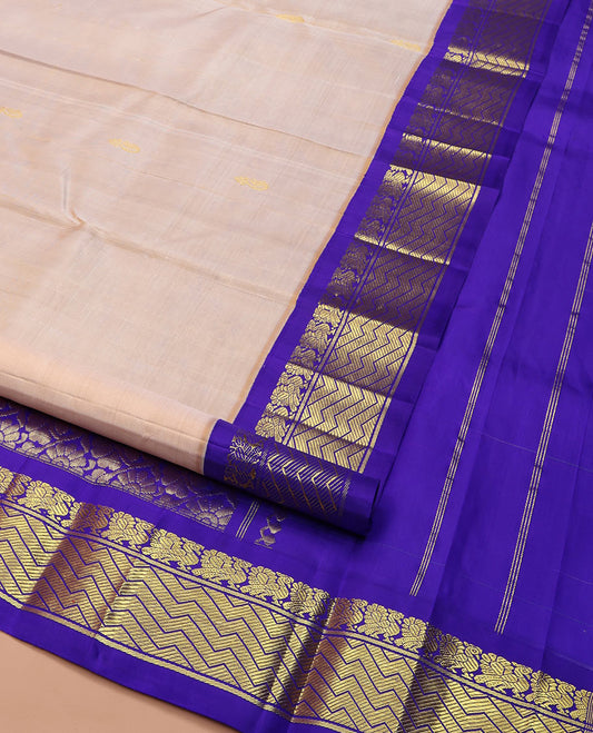 Light Sandal Kanchipuram Silk Saree, Delicately Woven with Zari Buttas on Its Body, Complemented by a Contrast One-Sided Korvai Border of Mayil, and Chevron Designs, Pallu of Floral Jaal Designs, and Comes Without a Blouse