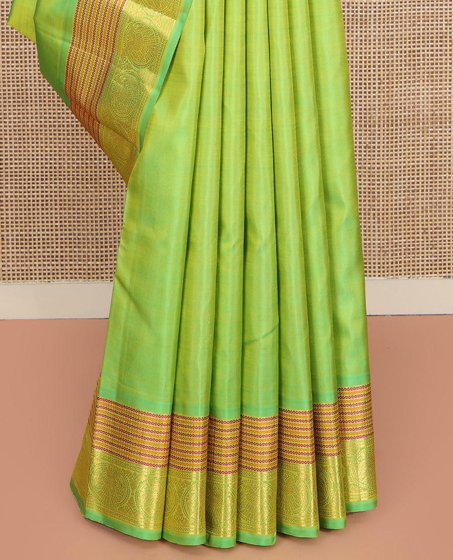 Green Plain Kanchipuram Silk Saree, Highlighted by Self-Border of Neli, and Round Iruthalai Pakshi Designs, Pallu of Same Design, and Paired with a Matching Blouse