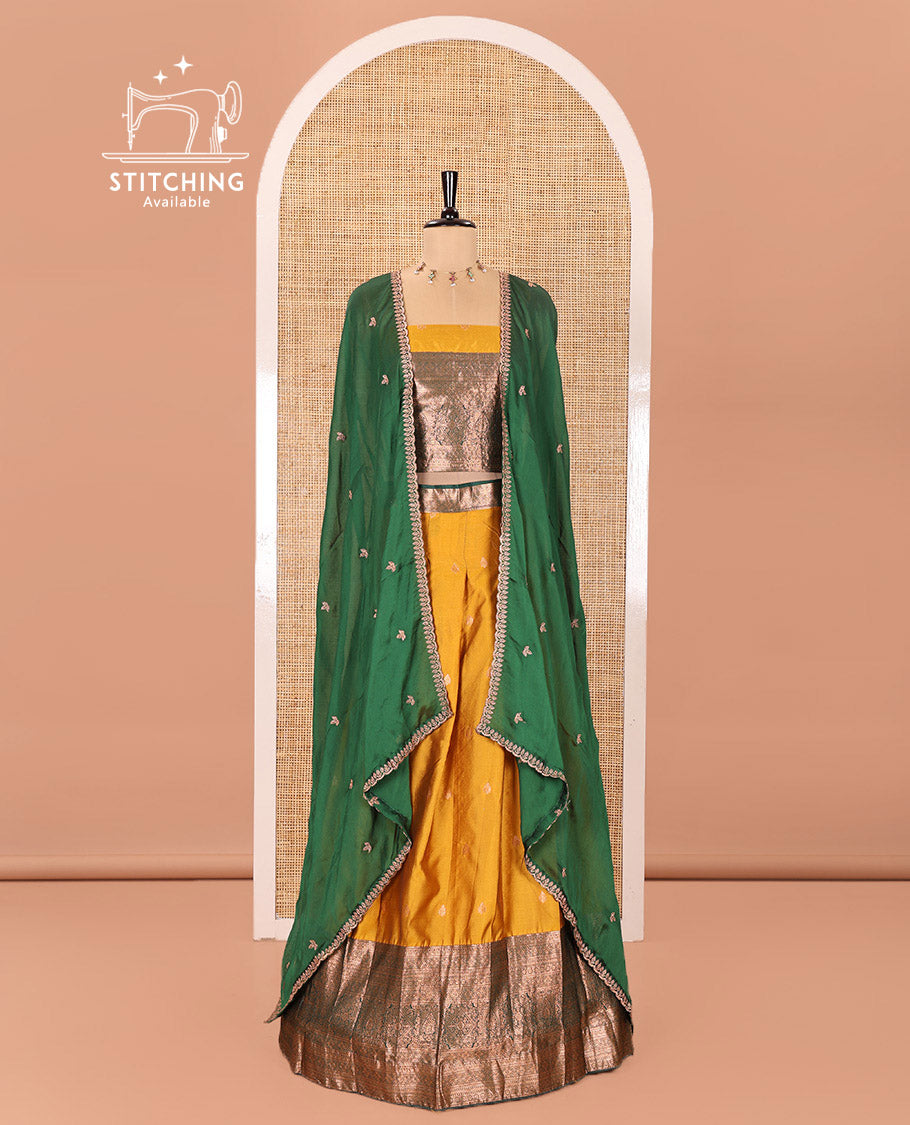 Yellow and Green Semi-Banarasi Half-Saree Beautified with Zari Buttas on Its Skirt, Complemented by a Contrast Traditional Zari Design Steeped Border, Paired with a Matching Blouse, and a Satin Georgette Embroidered Scallop Dhavani