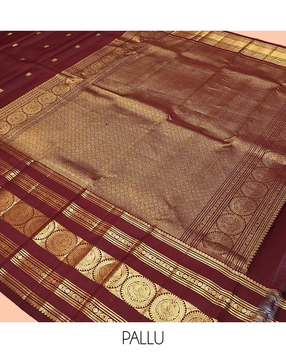 Maroon Kanchipuram Silk Saree, Crafted with Mayil and Chakram Buttas All Over Its Body, Highlighted by a Zari Border of Thilakam Mokku, Kathir, Kamalam, Manga, and Round Mayil Designs, Grand Jaal Pallu, and Paired with a Matching Blouse