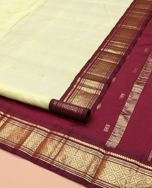 Light Green Kanchipuram Silk Saree, Delicately Woven with Zari Buttas on Its Body, Complemented by a Contrast One-Sided Border of Salngai, Banaras, Muthu, and Jaal Designs, Pallu of Zari Designs, and Comes Without a Blouse