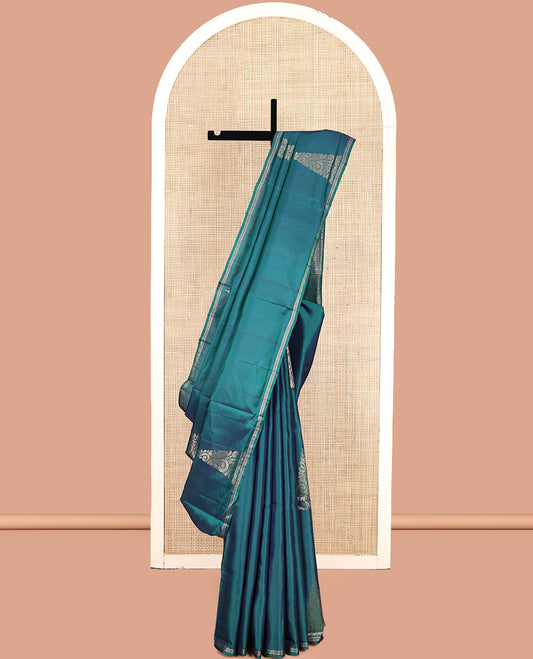 Peacock Blue Mayuri Lite Silk Mix Saree, Highlighted by Zari Buttas, a Subtle Piping Border, Pallu Steeped with Geometric Designs, and a Matching Blouse