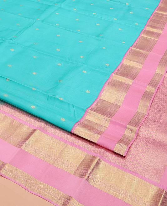 Blue Vasundhara Lite Silk Mix Saree, Adorned with Zari Buttas on Its Body, Complemented by a Contrast Retti Pettu Border of Thilakam, Banaras, Mayil Kann, Muthu, and Kamalam Designs, Pallu Steeped with Feather Motifs, and Paired with a Contrast Blouse