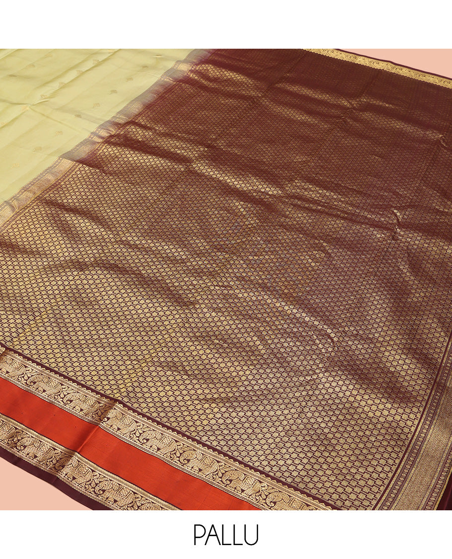 Green Vasundhara Silk Saree, Woven with Zari Buttas All Over Its Body Complemented by Contrast Rettai Pettu Border of Rekku and Yaanai Designs, Grand Pallu and Paired with a Contrast Blouse