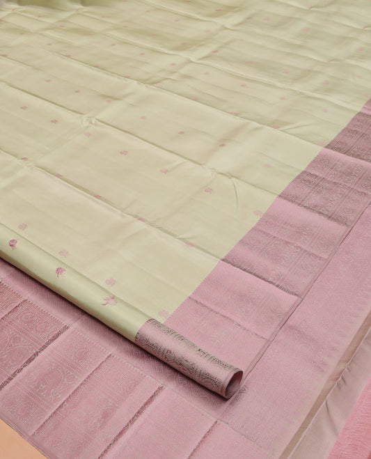 Green Kanchipuram Silk Saree, Subtly Enriched with Mayil-Chakram Buttas All Over Its Body, Complemented by a Contrast Border of Thilakam, Banaras, Mayil, Kathir, and Yaanai Designs, Pallu Steeped with Kamalam Designs, and Paired with a Contrast Blouse