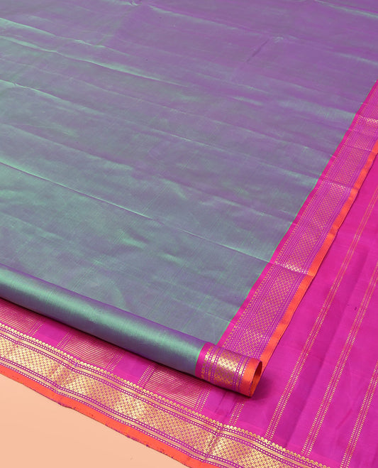 Green Plain Dual-Toned Kanchipuram Silk Saree, Complemented by a Captivating Contrast Border of Salngai, Muthu, Banaras, and Then Kuli Kann Designs, Gleaming Zari Woven Pallu, and Paired with a Contrast Blouse