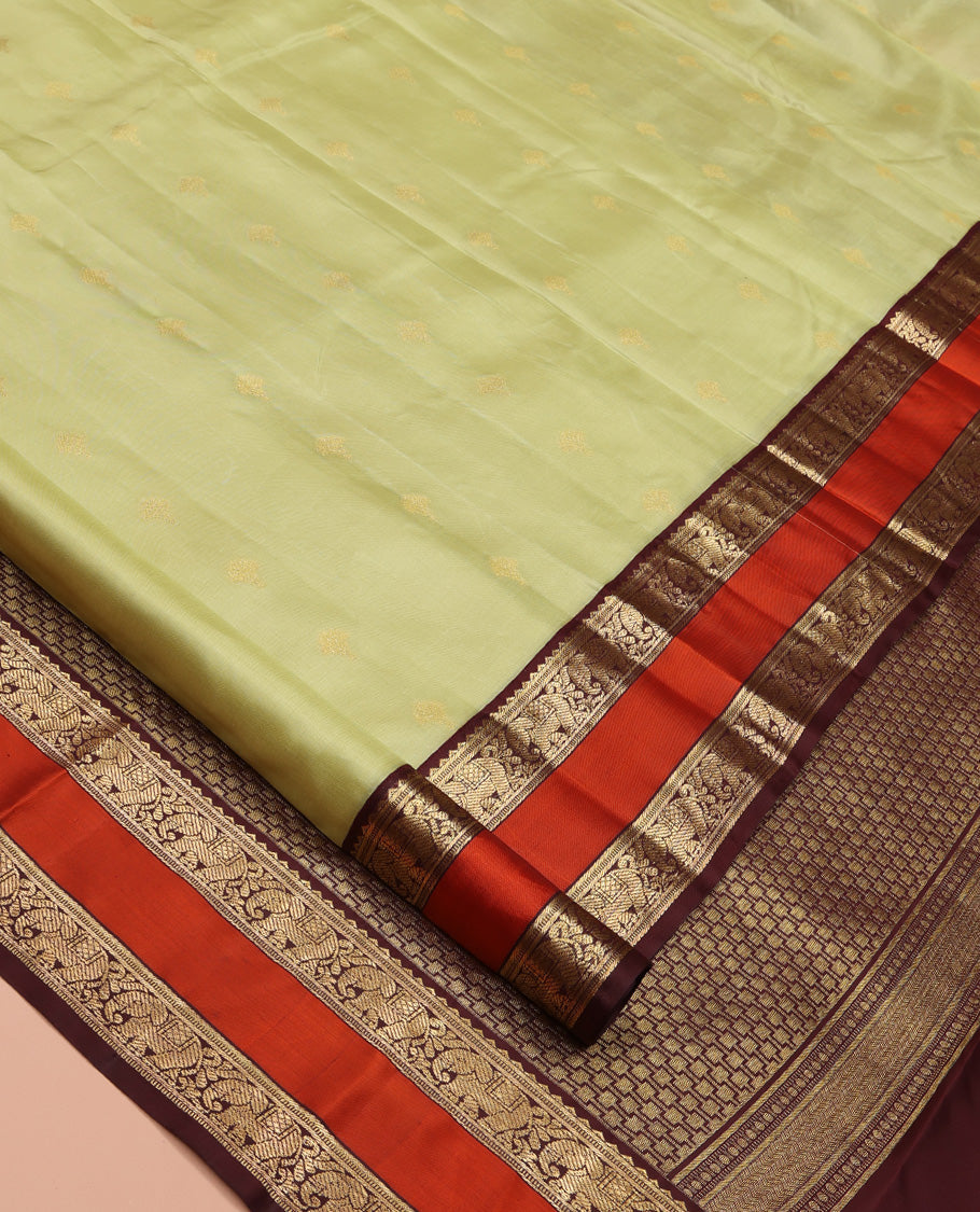 Green Vasundhara Silk Saree, Woven with Zari Buttas All Over Its Body Complemented by Contrast Rettai Pettu Border of Rekku and Yaanai Designs, Grand Pallu and Paired with a Contrast Blouse