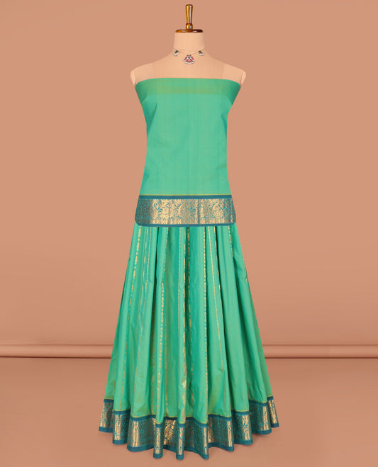 Green Art Silk Pavadai Material Set, Delicately Woven with Zari Designs on Its Skirt, Complemented by a Contrast Paisley Zari Border, and a Matching Blouse