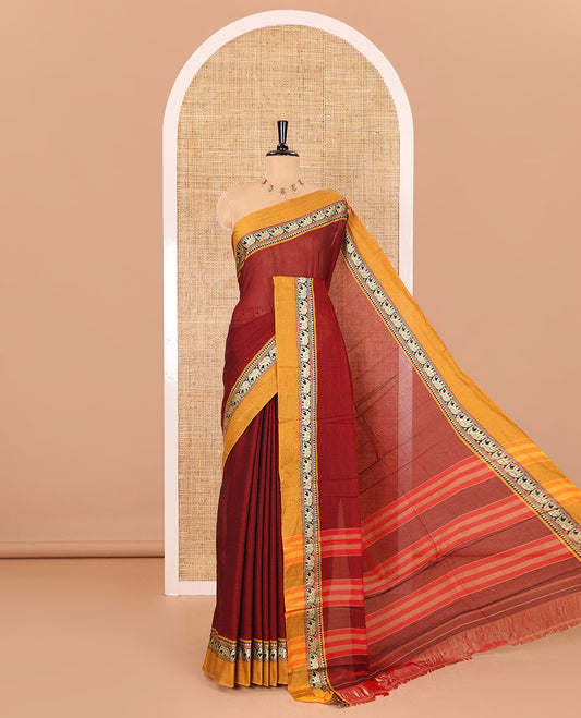 Maroon plain mercerised cotton saree, contrast kal erangina thread border of elephant motifs, striped pallu, and a matching blouse
