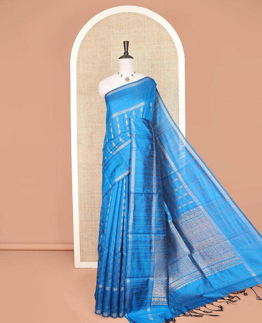 Blue Dupion Silk Saree, Graced with Floral Buttas All Over Its Body, Complemented by a Zari Striped Border, Sparsely Woven Pallu of Intricate Geometric Patterns, and Paired with a Matching Blouse