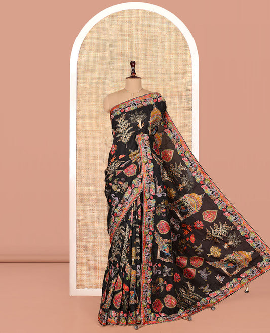 Black Dola Silk Saree, Featuring Colorful Flora, Fauna, and Mughal-Style Print on Its Body, Highlighted by Kaleidoscopic-Colored Floral-Bird Embroidered Border, Pallu Mirroring the Same Design, and Paired with a Contrast Blouse