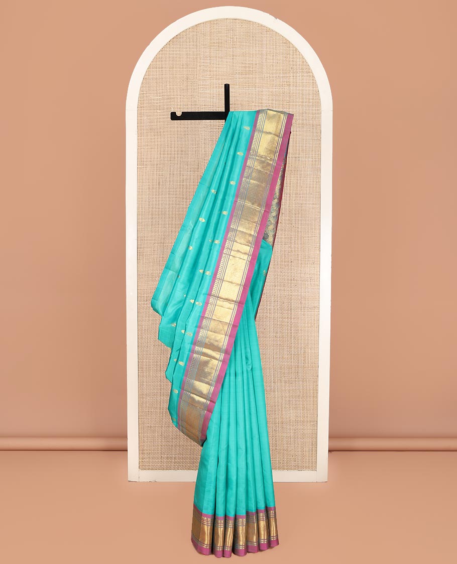 Blue Kanchipuram Silk Saree, Bedecked with Zari Buttas on Its Body, Complemented by a Contrast One-Sided Border of Panner Sombu, Banaras, and Jaal Designs, Pallu Features Floral Creeper Designs, and Comes Without a Blouse