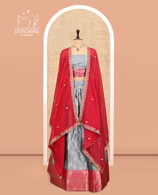 Grey Banarasi Half-Saree, Elevated with Floral Jacquard Design, a Contrast Traditional Zari Border, a Matching Blouse, and a Contrast Embroidered Dhavani