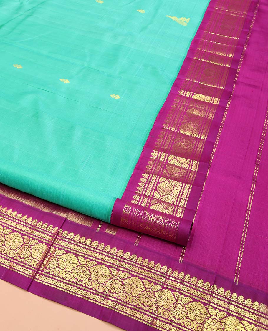 Blue Kanchipuram Silk Saree, Subtly Sparkled with Zari Buttas on Its Body, Complemented by a Contrast One-Sided Korvai Border of Rettai Neli, Banaras, and Floral Designs, Pallu of Paisley-Floral Designs, and Comes Without a Blouse