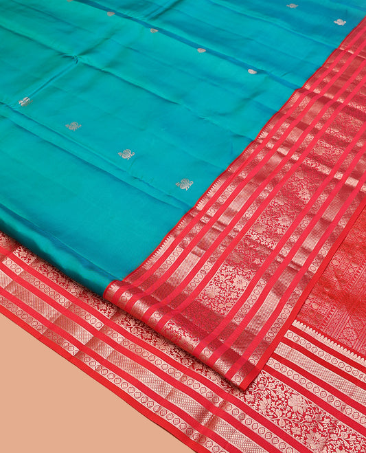 Rama Vasundhara Silk Saree, Accentuated with Zari Buttas All Over Its Body, Complemented by a Contrast Varisai Pettu Border of Thilakam, Neli, Laddu Kamalam, and Kodi Visiry Designs, Grand Pallu of Butta Enclosed Checks, and Paired with a Contrast Blouse