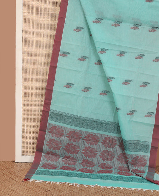 Blue leaf buttas kanchi cotton saree, contrast plain border, and floral design pallu