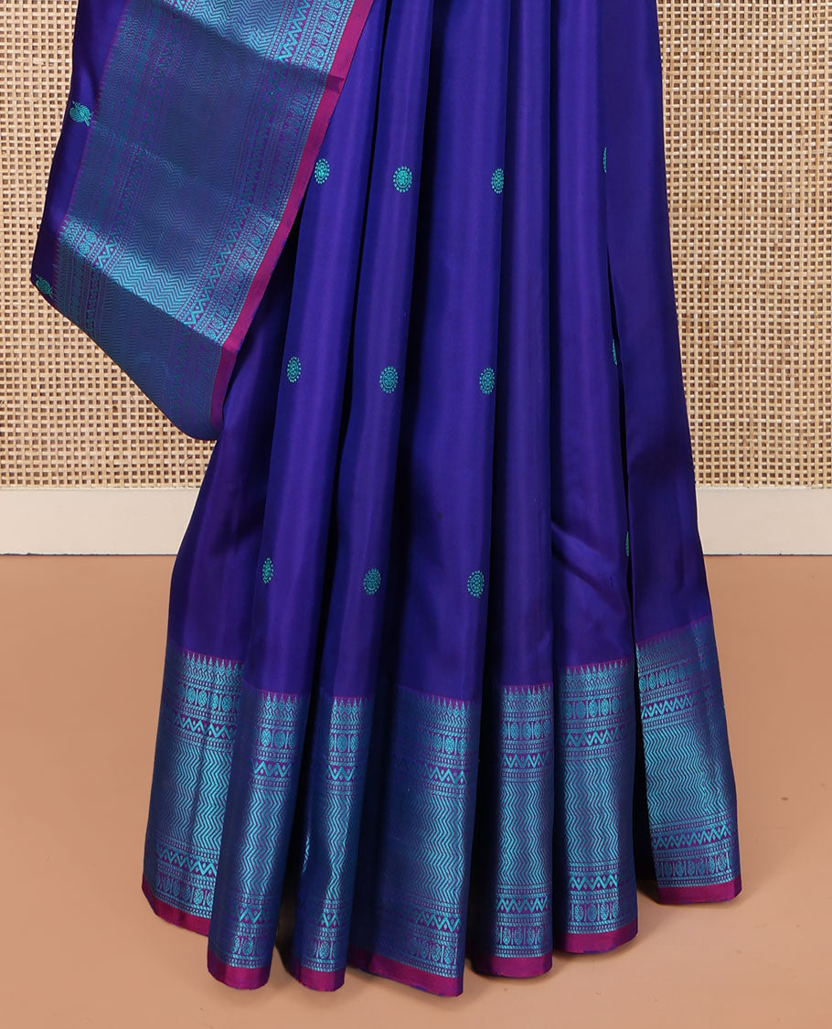 Blue Kanchipuram Silk Saree, Detailed with Mayil-Chakram Buttas All Over Its Body, Complemented by a Contrast Border of Thilakam, Banaras, Muthu, Rudraksham, Neli, and Vanki Designs, Pallu Steeped with Kamalam Designs, and Paired with a Contrast Blouse