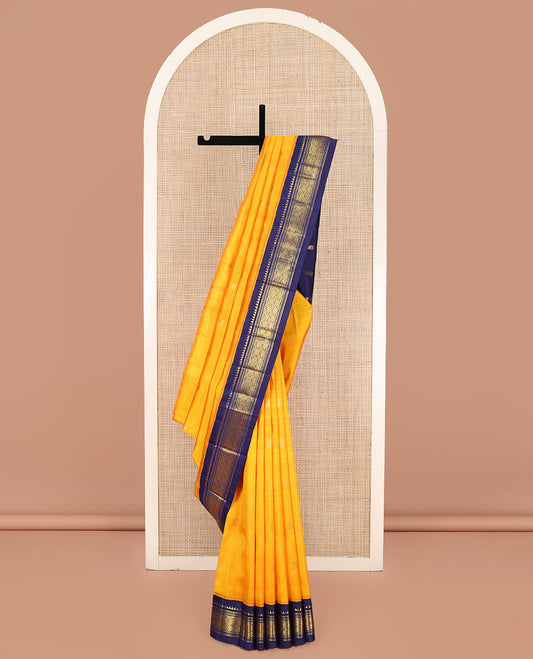 Yellow Kanchipuram Silk Saree, Sparsely Woven with Zari Buttas on Its Body, Complemented by a Contrast One-Sided Korvai Border of Rekku, Muthu, Banaras, and Jaal Designs, Pallu Features Zari Designs, and Comes Without a Blouse