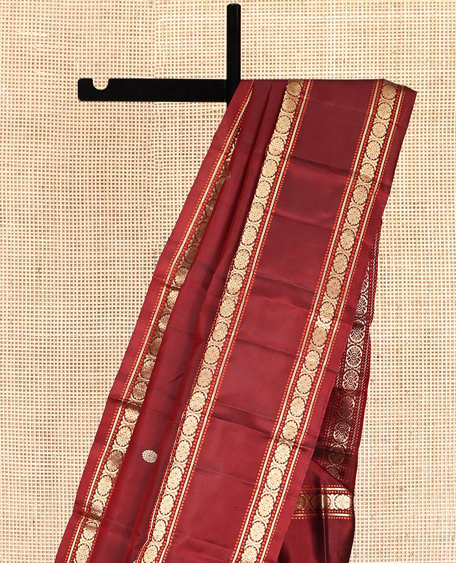 Maroon Kanchipuram Silk Saree, Adorned with Chakram Buttas, Highlighted by a Rettai Pettu Zari Border of Muthu, Banaras, and Cross Kamalam Designs, Mayil-Chakram Pallu and a Matching Blouse