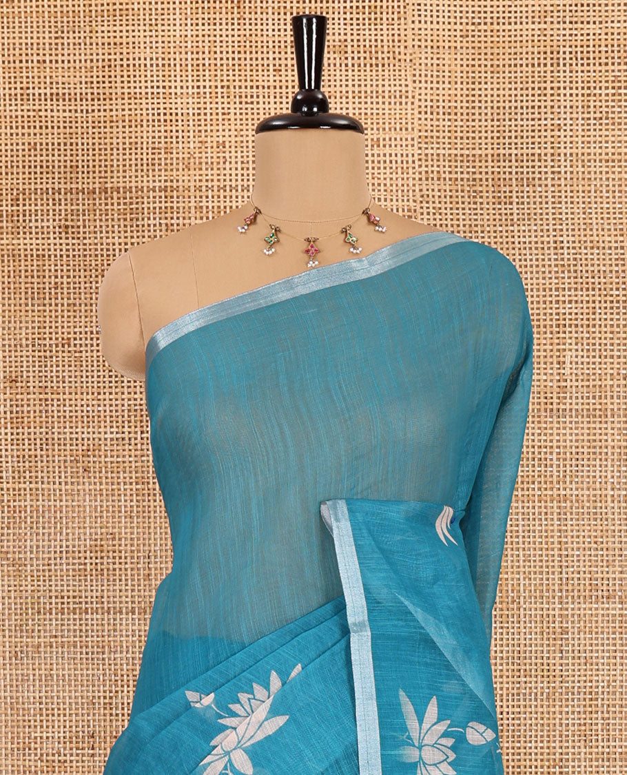 Peacock Pichwai lotus printed linen cotton saree, piping zari border, colorful tasselled lotus printed pallu, and a contrast lotus printed blouse