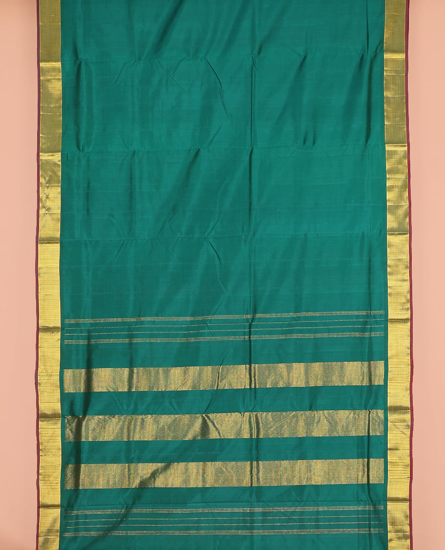 Dark green plain nine-yard silk saree, zari border, and pallu of zari designs