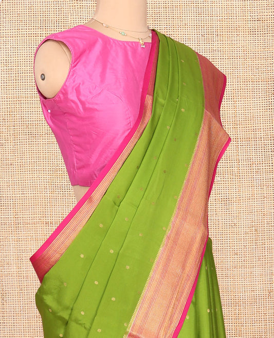 Green Mysore Silk Saree, Detailed with Zari Buttas All Over Its Body, Complemented by a Contrast Zari Border of Traditional Designs, Grandly Zari Decked Up Pallu of Jaal Designs, and Paired with a Contrast Blouse