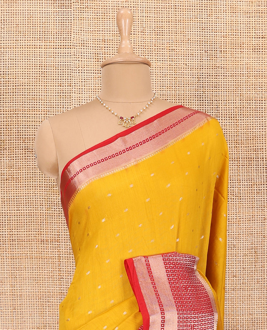 Yellow Assam Silk Saree Adorned with All-Over Buttas, Featuring a Contrast Temple Border of Butta Enclosed Checked Design, a Pallu Steeped with Zari Stripes, and Paired with a Contrast Zari Design Blouse