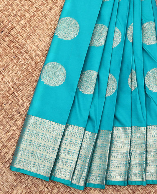 Blue Budget Silk Saree, Gleamed Up with Round Peacock Buttas All Over Its Body, Highlighted by a Traditional Zari Border of Paisley Designs, Captivating Contrast Jaal Pallu, and Paired with a Contrast Blouse