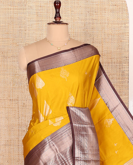 Yellow Budget Silk Saree, Ornamented with Zari Buttas All Over Its Body, Complemented by Contrast Border of Traditional Designs Woven in Zari, Gracefully Embellished Pallu, and Paired with a Contrast Blouse