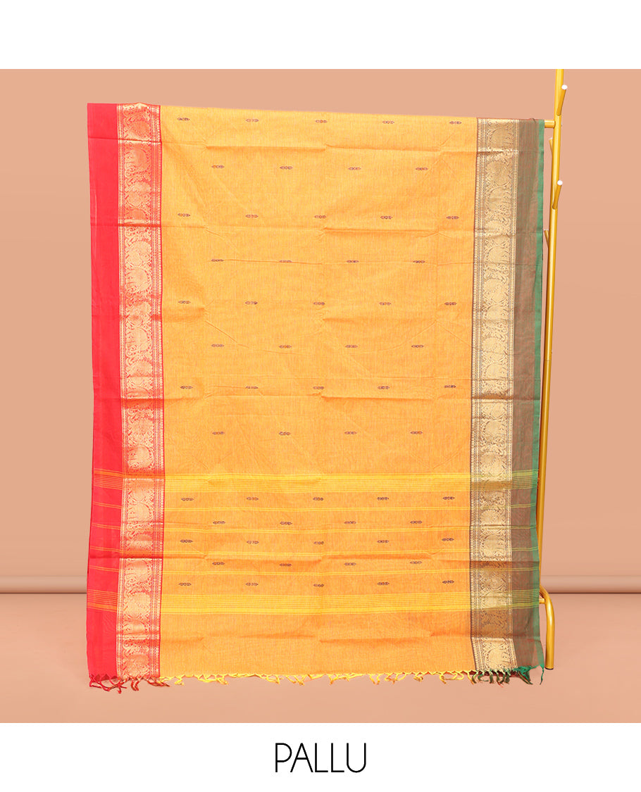 Yellow Chettinad Cotton Saree, Decked Up with Thread Buttas All Over Its Body, Complemented by a Contrast Ganga-Jamuna Kal Eragina Border of Kodi Peacock and Elephant Designs, Pallu of Buttas and Stripes, and Paired with a Matching Blouse