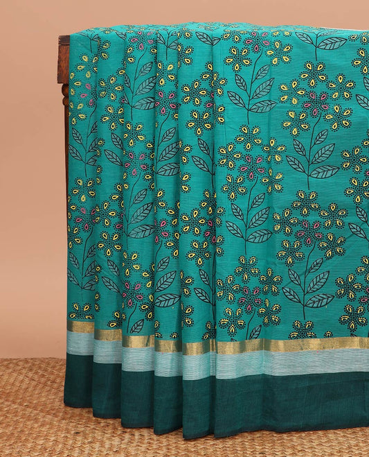 Teal blue floral and leaf printed chirala cotton saree, contrast zari border, and pallu of floral print