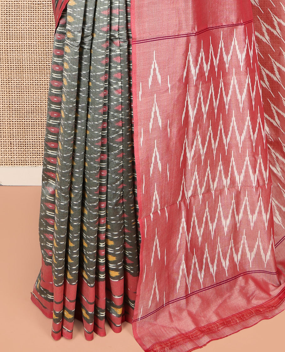 Grey Ikkat Cotton Saree, Enriched with Ikkat-Style Ogee Patterns All Over Its Body, Complemented by a Contrast Ikkat-Style Border, Pallu of Chevron Patterns, and Has No Blouse
