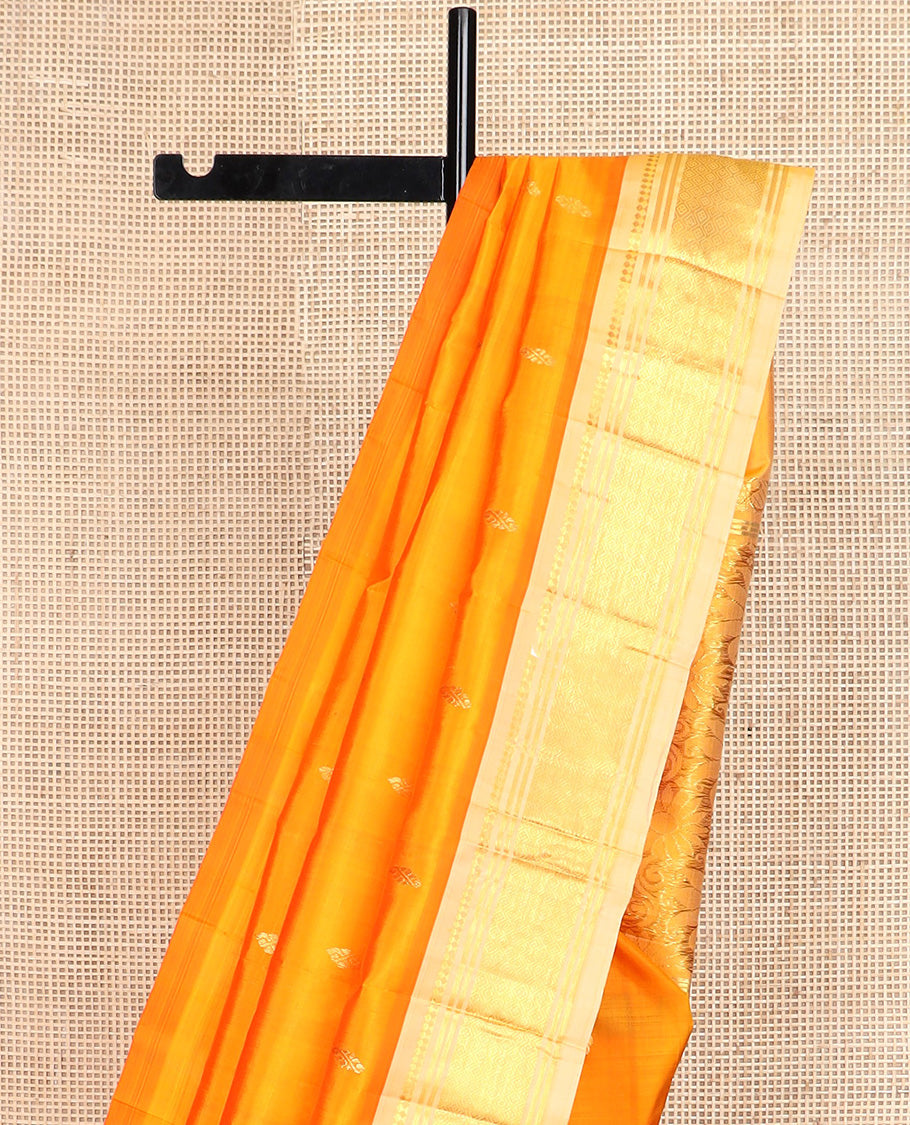 Orange zari buttas Kanchipuram silk saree, contrast one-sided border of paneer sombu, banaras, and jaal design, and zari design pallu